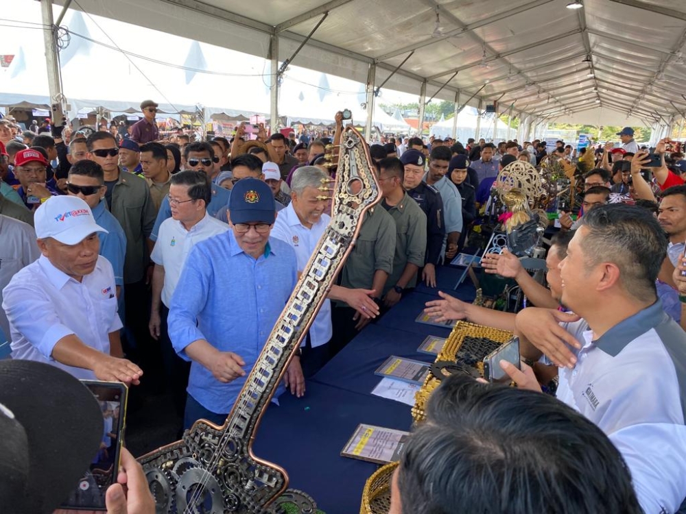 Prime Minister Datuk Seri Anwar Ibrahim visiting the booths at a community session on TVET at Bertam Square in Kepala Batas, July 16, 2023. — Picture by Opalyn Mok