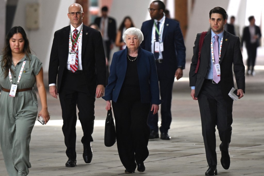 US Treasury Secretary Janet Yellen (centre) arrives to address a press conference ahead of the G20 Finance Ministers, Central Bank Governors (FMCBG) and Finance and Central Bank Deputies (FCBD) meetings, at the Mahatma Mandir in Gandhinagar, India, on July 16, 2023. — AFP pic