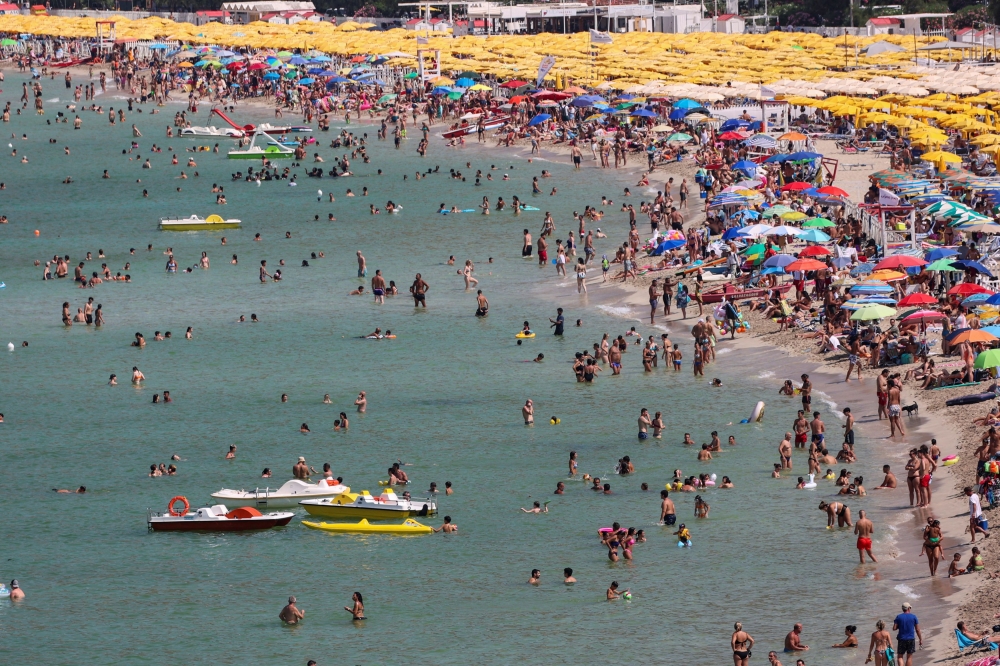 People cool off at Mondello beach, during a heatwave across Italy, in Palermo, Italy, July 15, 2023. — Reuters pic