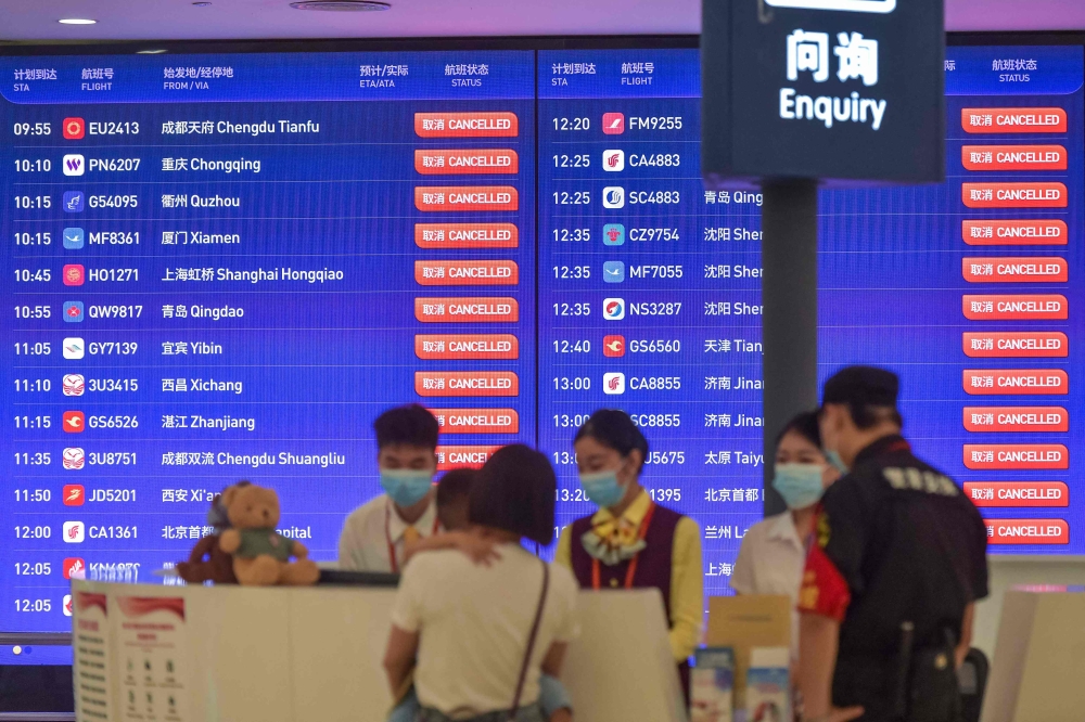 A screen shows cancelled flights at Haikou Meilan International Airport as a precaution for the approaching Typhoon Talim, in China's southern Hainan province on July 17, 2023. — Picture by CNS via AFP