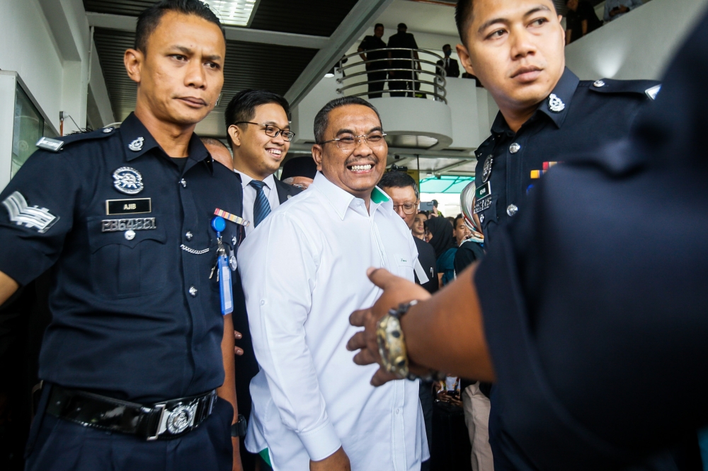 Caretaker Kedah mentri besar Datuk Muhammad Sanusi Md Nor (centre) is seen leaving the Selayang Court Complex July 18, 2023. — Picture by Hari Anggara