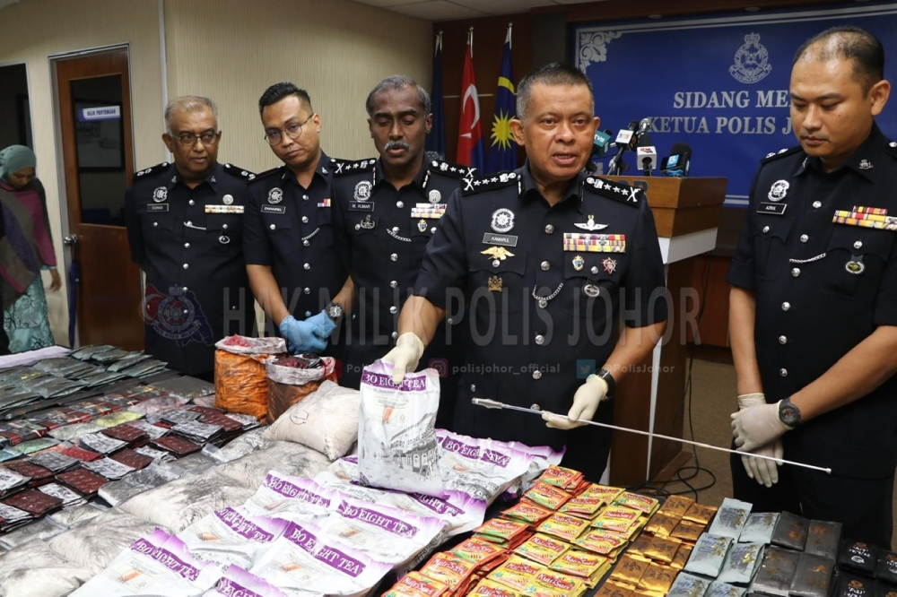 Johor police chief Datuk Kamarul Zaman Mamat (centre) shows the seized drugs at the Johor police contingent headquarters in Johor Baru July 20, 2023. — Picture courtesy of Johor police