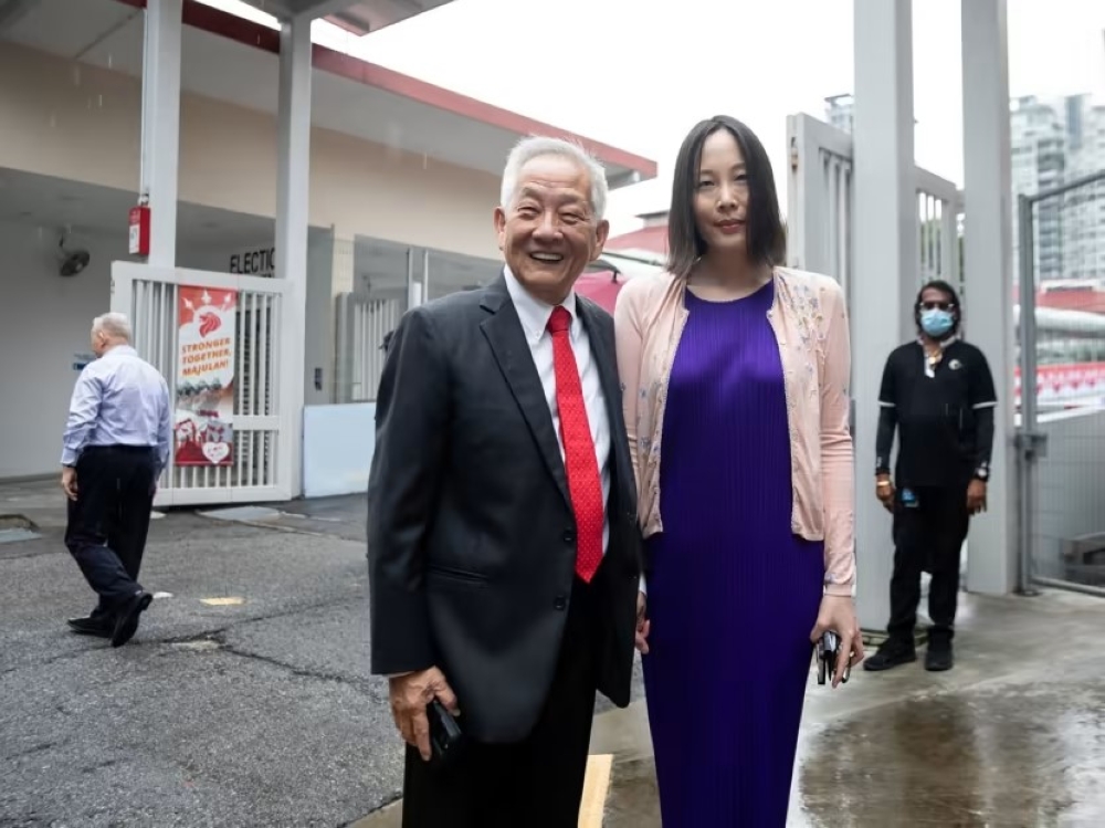 Ng Kok Song (left) and fiancee Sybil Lau at the Elections Department on July 19, 2023. — TODAY