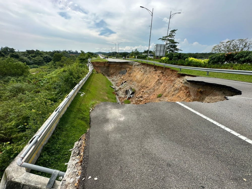 A collapsed section of a road between Forest City and the Tanjung Pelepas Port highway is visible in this July 23, 2023 image. — Picture courtesy of the Johor Fire and Rescue Department