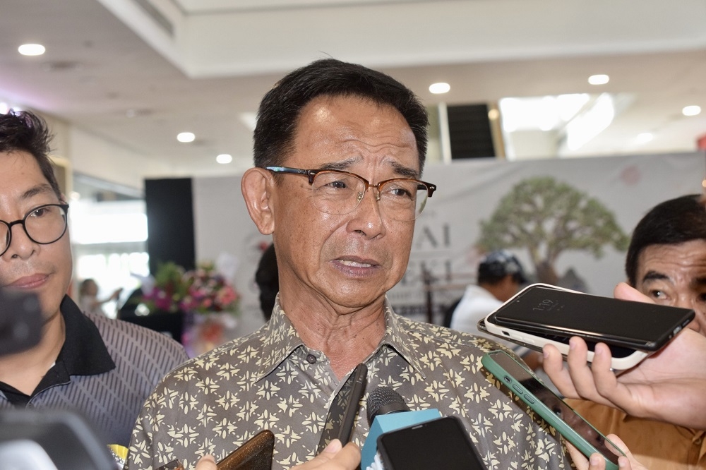 Sarawak Minister of Tourism, Creative Industry and Performing Arts Datuk Seri Abdul Karim Rahman Hamzah speaks to the reporters when met at the event in Kota Samarahan July 23, 2023. — Borneo Post pic
