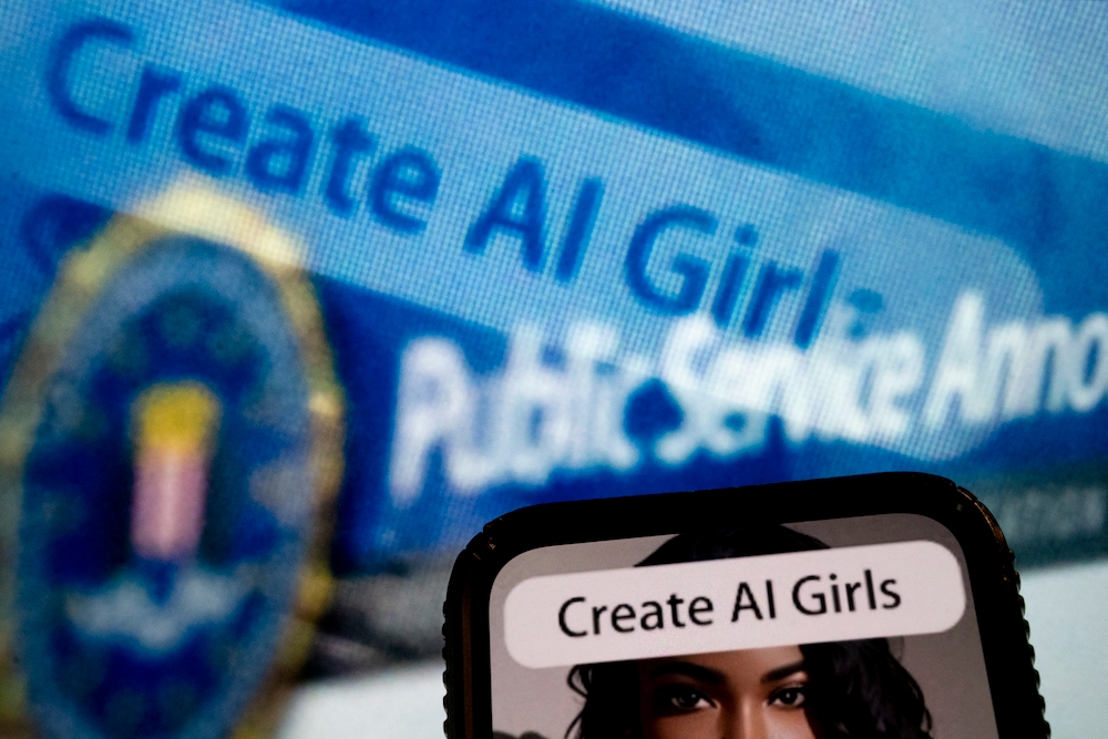 This photo illustration created on July 18, 2023, in Washington, DC, shows an advertisement to create AI girls reflected in a public service announcement issued by the FBI regarding malicious actors manipulating photos and videos to create explicit content and sextortion schemes. — AFP pic