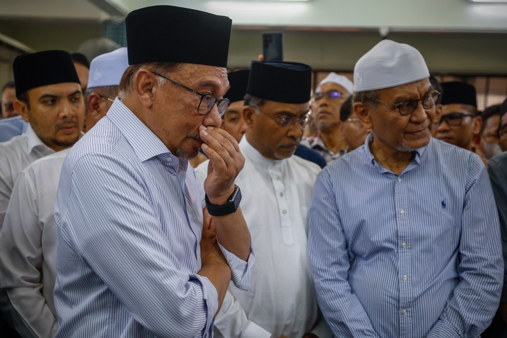 Prime Minister Datuk Seri Anwar Ibrahim (left) attends the funeral prayers for Datuk Seri Salahuddin Ayub at Masjid Jamek Dato’ Haji Noh Gadot in Serkat, Pontian July 24, 2023. — Bernama pic