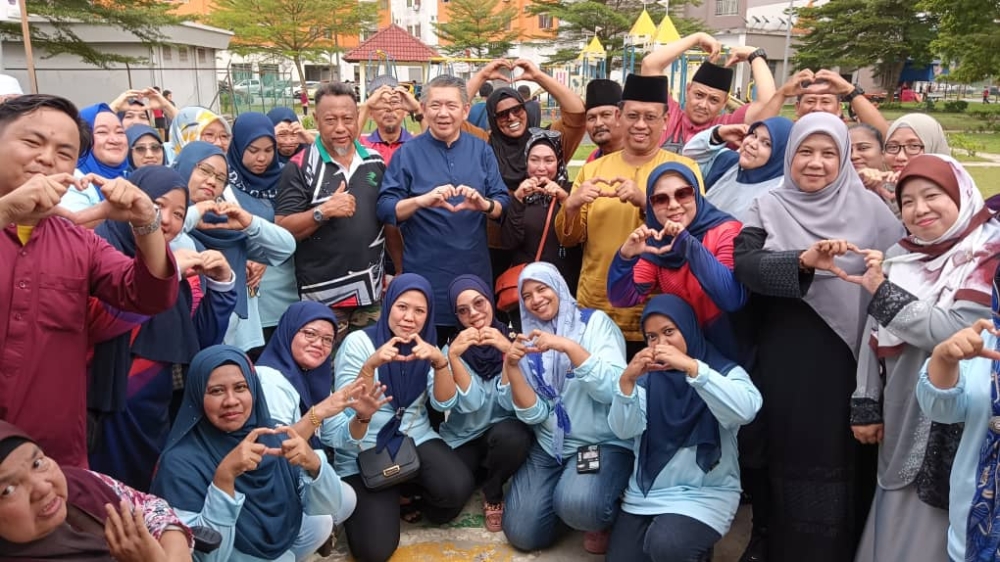 An undated photograph shows Datuk Seri Salahuddin Ayub (centre) with residents at a community programme at PPR Melana Indah in Johor Baru. — Picture courtesy of Zarith Sofieah M Yusof