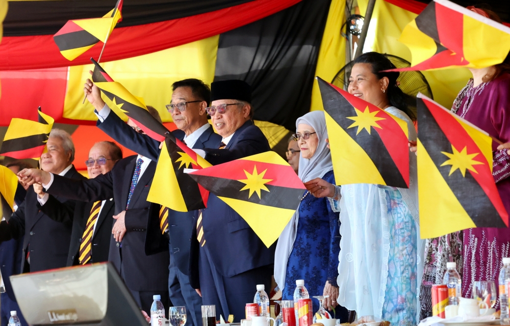 Sarawak Premier Tan Sri Abang Johari Openg and Puan Sri Juma’ani Tuanku Bujang wave the state flag at the contingent procession in conjunction with the celebration of Sarawak’s 60th Independence Day at Padang Merdeka, July 22, 2023. Also present were the three deputy premiers Datuk Amar Awang Tengah Ali Hasan, Datuk Amar Douglas Uggah Embas, and Datuk Seri Sim Kui Hian, as well as state Tourism, Arts, and Culture Minister Datuk Seri Abdul Karim Rahman Hamzah. — Bernama pic 
