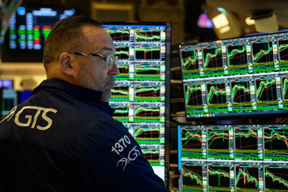 Stocks tread water while dollar dips after latest Fed rate hike | Malay ...