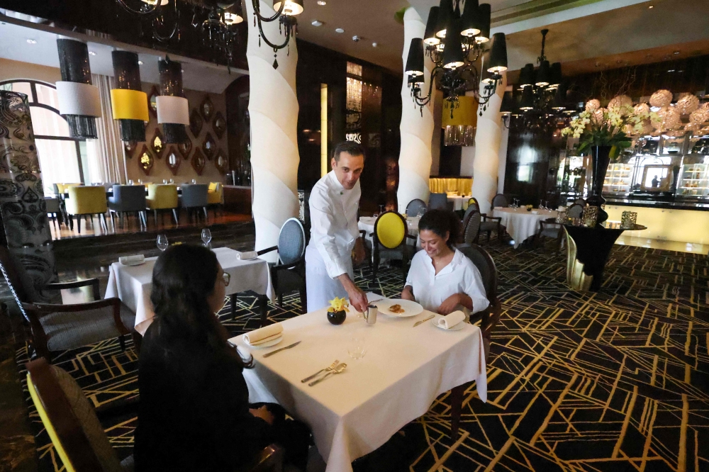 French chef Renaud Dutel serves a dish at STAY by Yannick Alleno restaurant in Dubai on July 7, 2023. — AFP pic