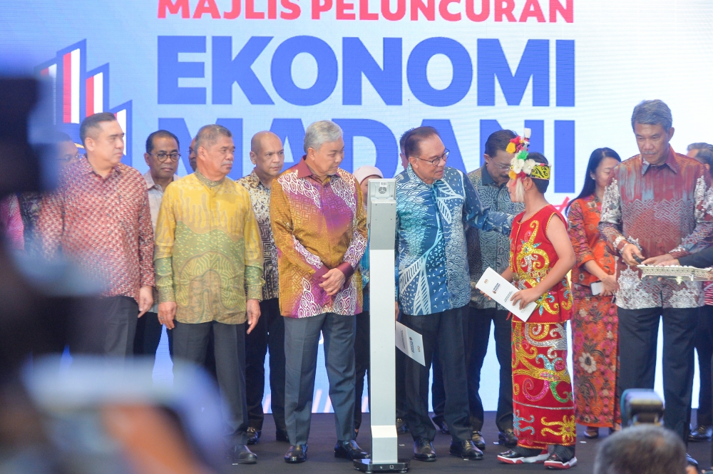 Prime Minister Datuk Seri Anwar Ibrahim (fourth, left) launching the 'Madani Economy: Empowering the People' framework in Kuala Lumpur July 27, 2023. — Picture by Shafwan Zaidon
