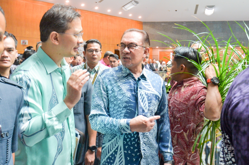 Prime Minister Datuk Seri Anwar Ibrahim (right) attends the launch of the 'Madani Economy: Empowering the People' framework in Kuala Lumpur July 27, 2023. — Picture by Shafwan Zaidon
