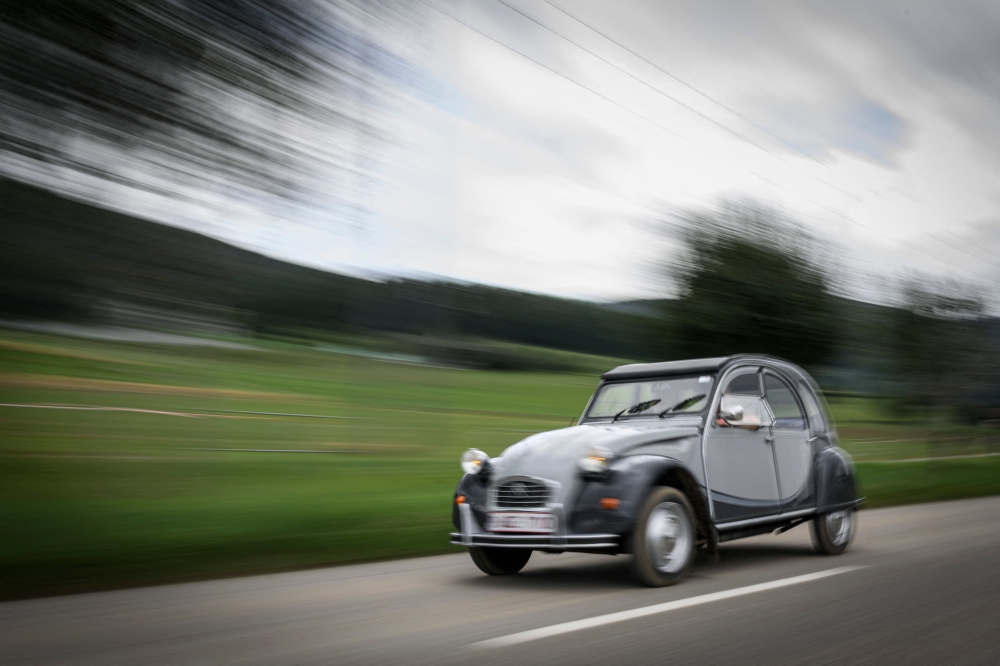 A car drives to the 24th World meeting of Citroen 2CV friends near Delemont, northern Switzerland on July 26, 2023. — AFP pic