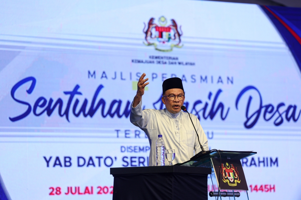 Prime Minister Datuk Seri Anwar Ibrahim delivers a speech at the ‘Sentuhan Kasih Desa Terengganu’ programme at Bandar Al Muktafi Billah Shah in Dungun July 28, 2023. — Bernama pic