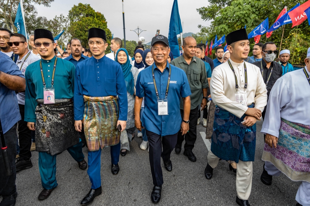 Perikatan Nasional candidates for Sungai Tua seat Muhammad Hanif Jamaluddin, Hulu Kelang seat Datuk Seri Mohamed Azmin Ali, and Gombak Setia seat Muhammad Hilman Idham seen with Perikatan Nasional chairman Tan Sri Muhyiddin Yassin at the nomination centre in SMK Sungai Pusu Gombak, Selangor July 29, 2023. — Picture by Firdaus Latif
