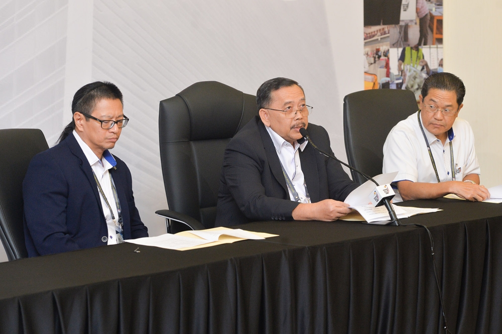 Election Commission chairman Tan Sri Abdul Ghani (centre) speaks during a press conference in Putrajaya July 29, 2023. — Picture by Miera Zulyana