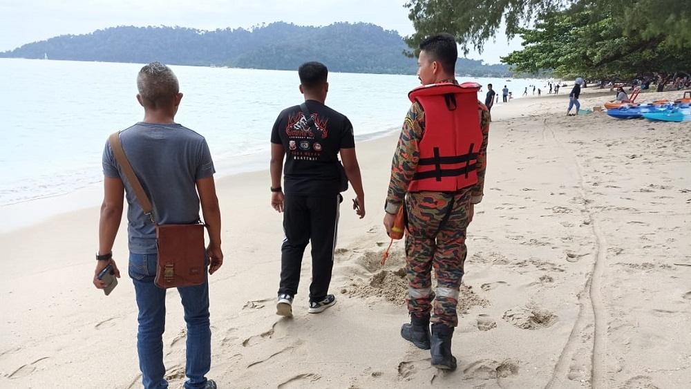 Perak Fire and Rescue Department personnel are seen during the search operation at the Teluk Senangin beach area in Lumut July 29, 2023. — Picture courtesy of JBPM Perak