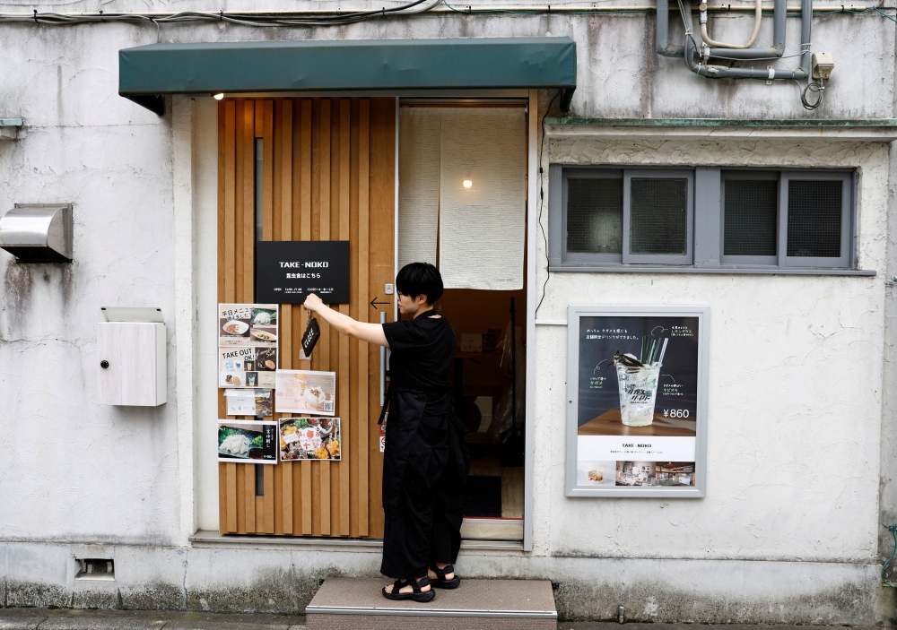 Michiko Miura, the manager of Take-Noko cafe, opens the cafe in Tokyo, Japan, July 21, 2023. — Reuters pic