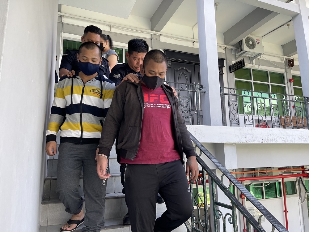 Syahadan (left) and Ting are escorted from the court after sentencing. — Borneo Post Online pic