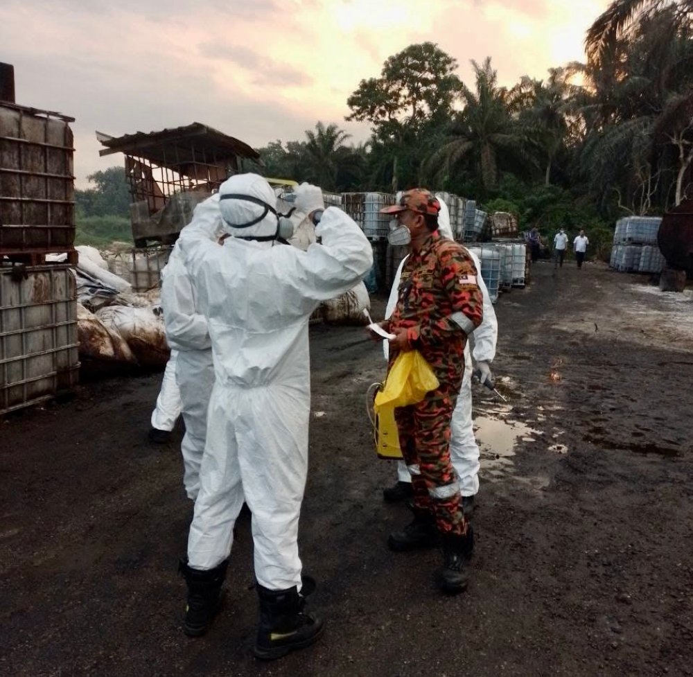 Firemen and hazmat personnel checking for the source of a foul chemical odour after students and stafff at SK Sungai Tiram in Ulu Tiram fell sick, August 3, 2023. ― Picture courtesy of the Johor Fire and Rescue Department