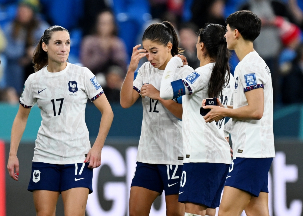 France's Amel Majri, Lea Le Garrec, Clara Mateo and Elisa De Almeida react after the match after qualifying for the knockout stages of the World Cup August 2, 2023. ― Reuters pic