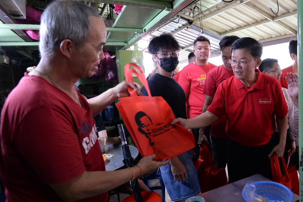 Caretaker chief minister of Penang Chow Kon Yeow (right) was warmly received during his campaign walkabouts in his Padang Kota constituency. — Picture by KE Ooi