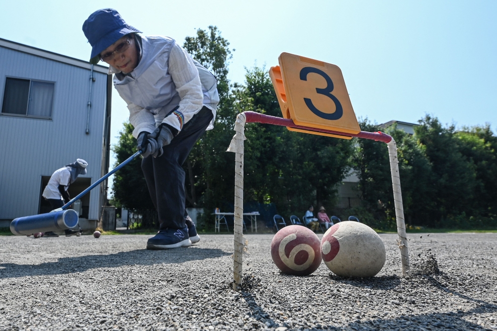 This photo shows senior citizens playing the croquet-inspired game of 