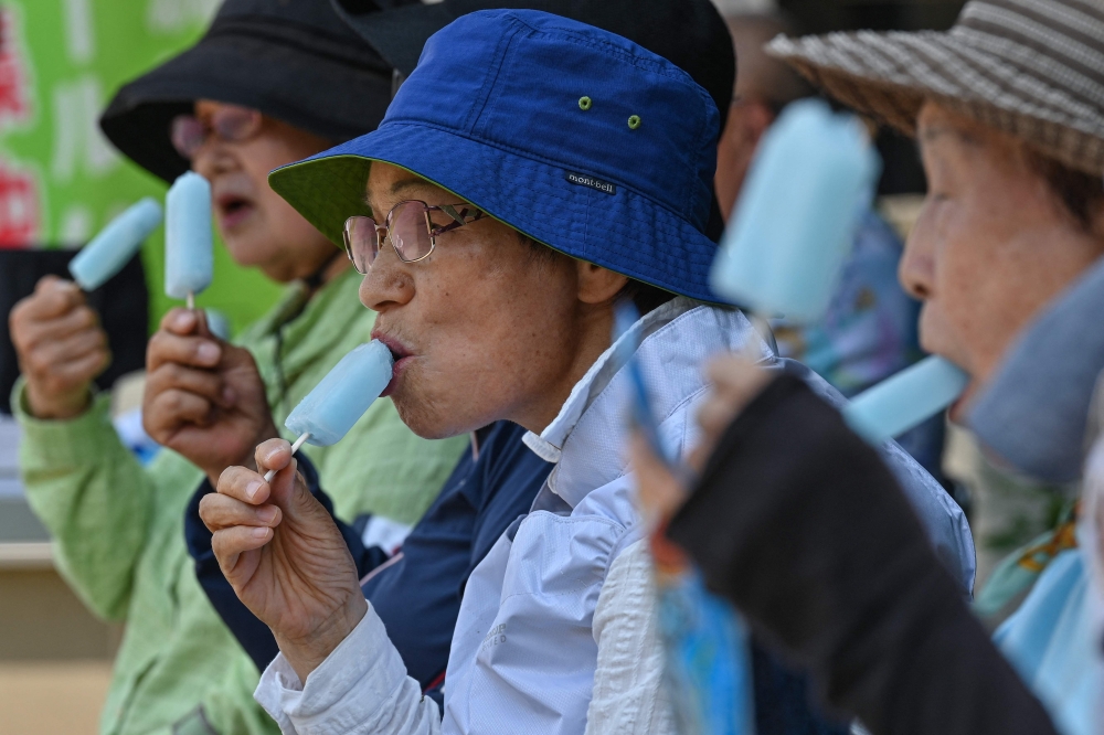 Senior citizens enjoying cool popsicles after playing the croquet-inspired game of 