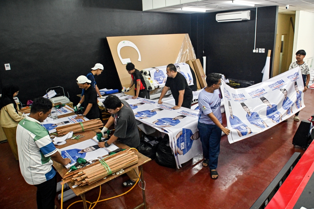 Workers at a print shop prepare posters to be used for the state election in Paya Bunga, Terengganu, August 2, 2023. — Bernama pic 