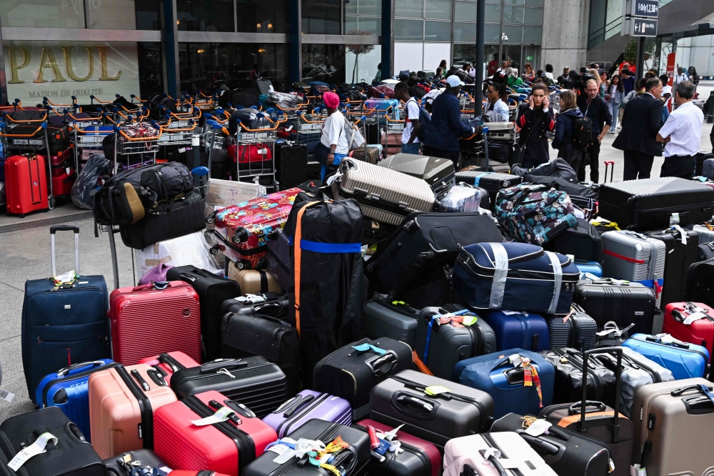 With just one year to go before Paris hosts the Olympic Games, one of the city’s airports suffered an unprecedented breakdown yesterday that led to a mountain of luggage piling up and delayed flights. — AFP pic