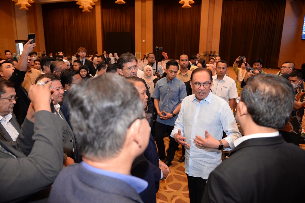 Prime Minister Datuk Seri Anwar Ibrahim being greeted by participants at the National Economic Conference in Seberang Perai August 5, 2023. — Picture by KE Ooi