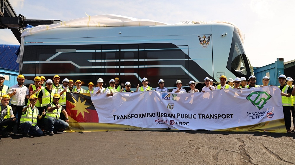 Sarawak Economic Development Corporation chairman Tan Sri Abdul Aziz Husain (8th right) and those present pose for a group photograph with the prototype unit in the background. — Borneo Post pic