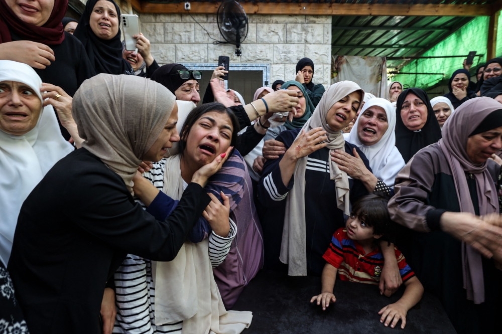 Mourners react during the funeral of Mahmoud Abu Saan, a Palestinian teenager shot dead by Israeli forces earlier this morning, in the occupied West Bank town of Tulkarm, on August 4, 2023. ― AFP pic