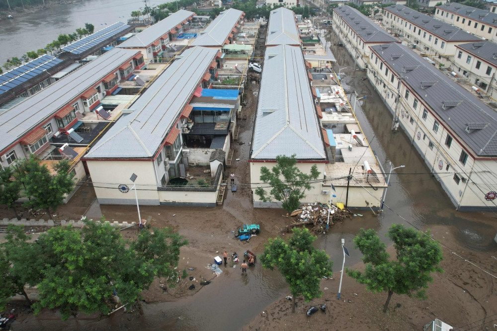 File photo of the aerial view showing a flooded village in the aftermath of the flooding following heavy rains in Beijing on August 3, 2023. ― AFP pic