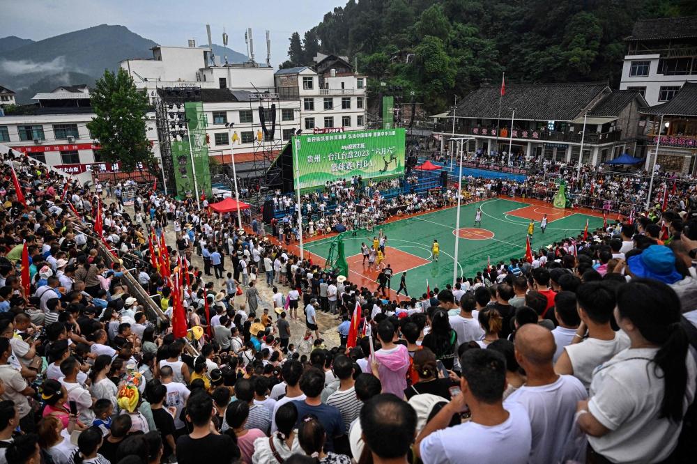 This photo taken on July 30, 2023 shows a general view of spectators watching a game of the grassroots basketball competition CunBA in Taipan village, Taijiang county, in southwestern China's Guizhou province. — AFP pic