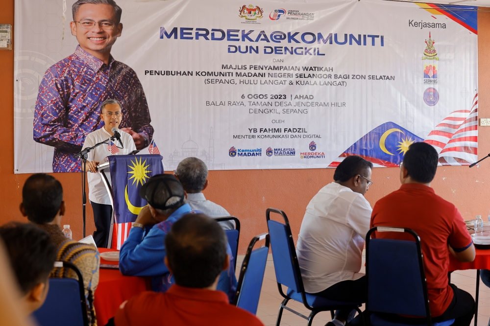 Communications and Digital Minister Fahmi Fadzil delivers a speech while officiating the Merdeka@Komuniti programme for the Dengkil state constituency at Balai Raya Taman Desa Jenderam Hilir, Dengkil  August 6, 2023. — Bernama pic