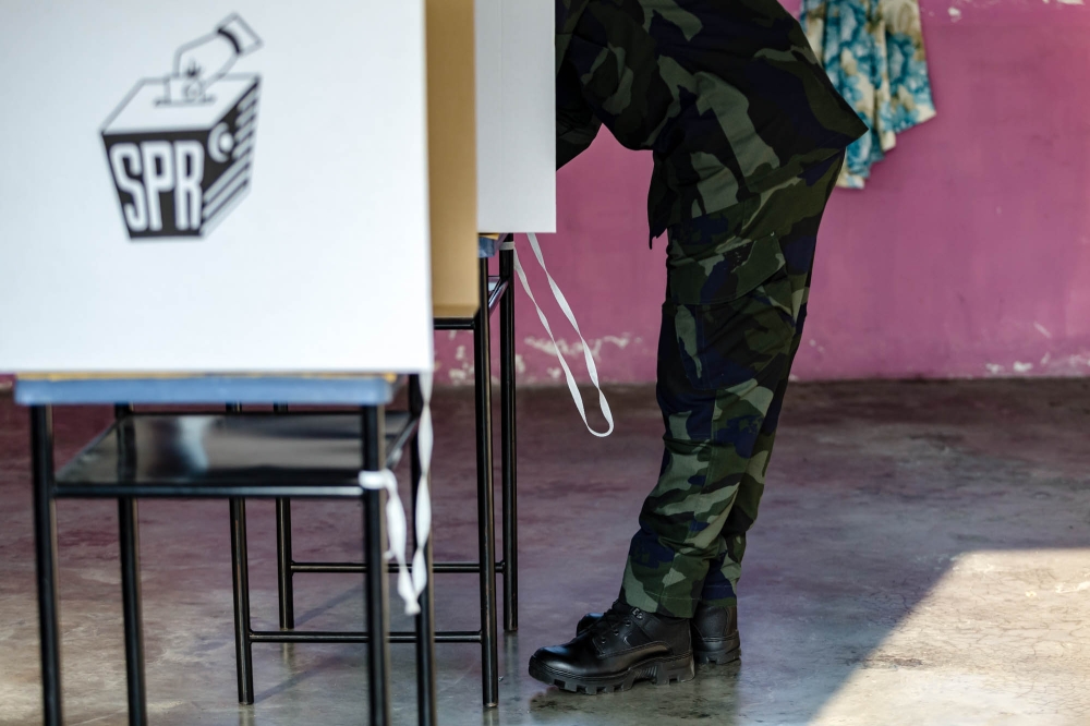 A member of the General Operations Force casts his ballot in Cheras August 8, 2023. — Picture by Firdaus Latif