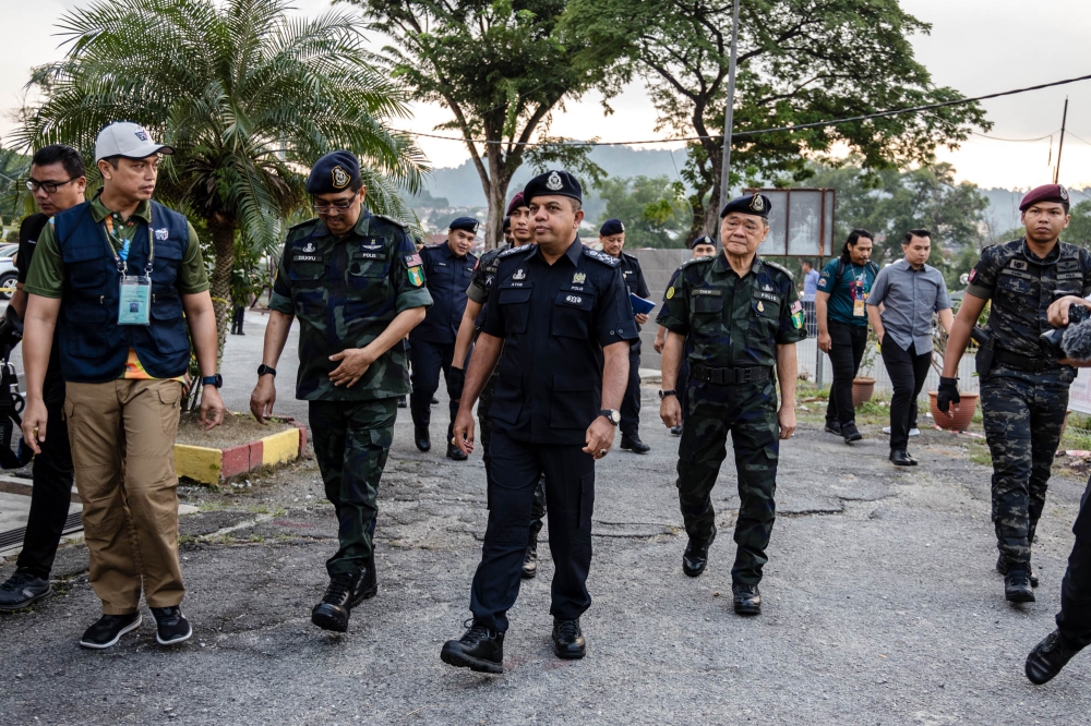 Deputy Inspector-General of Police Datuk Seri Ayob Khan Mydin Pitchay (centre) at the early voting centre located at GOF Central Brigade Headquarters in Cheras August 8, 2023. — Picture by Firdaus Latif