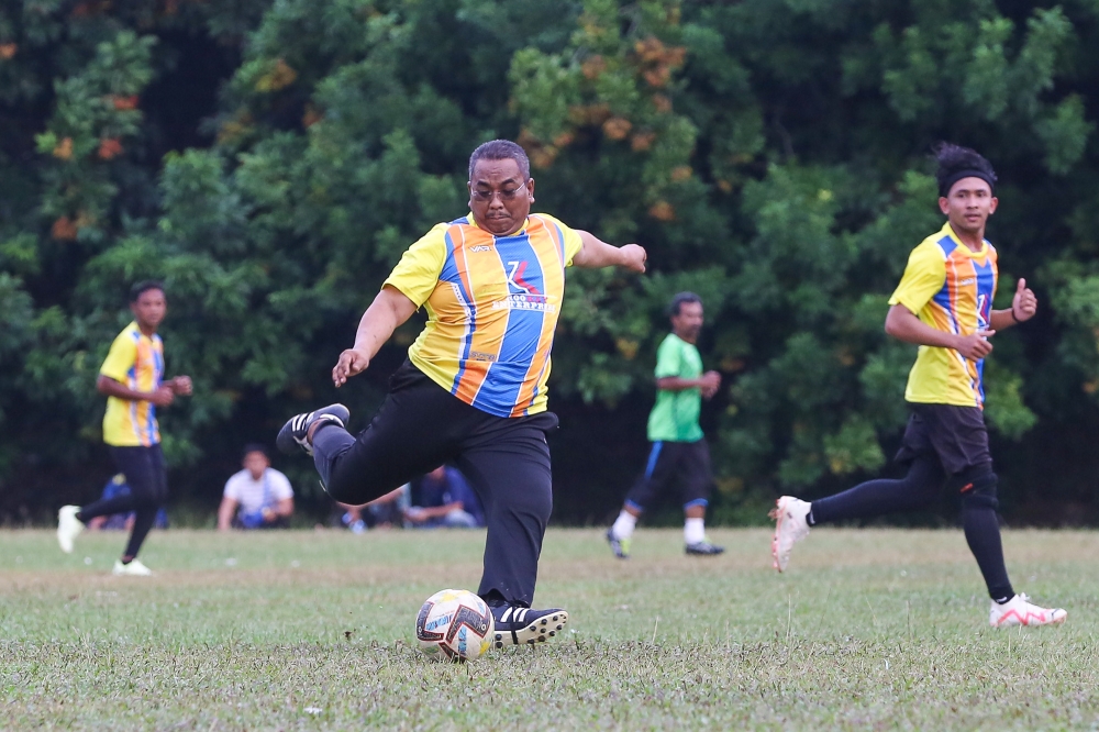 Caretaker Kedah menteri besar Datuk Muhammad Sanusi Md Nor in action during a friendly football match at Felda Teloi Timur in Kuala Ketil, Kedah, August 7, 2023. — Picture by Yusof Mat Isa