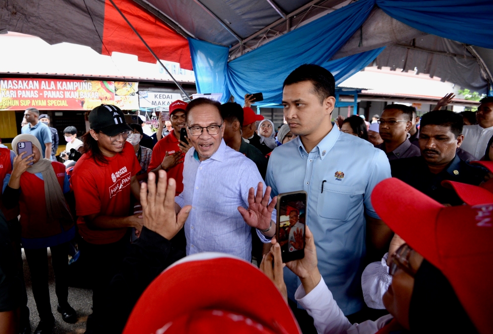 Prime Minister Datuk Seri Anwar Ibrahim being greeted during his visit to Sungai Bakap, Penang, August 8, 2023. — Picture by KE Ooi