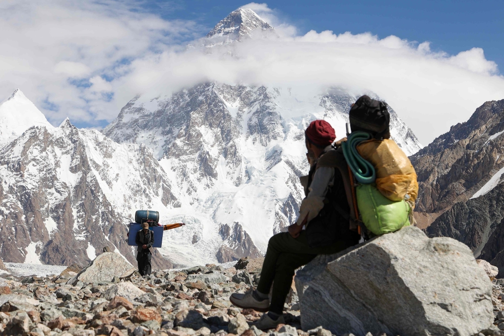 A Pakistani porter looking towards K2. — AFP pic