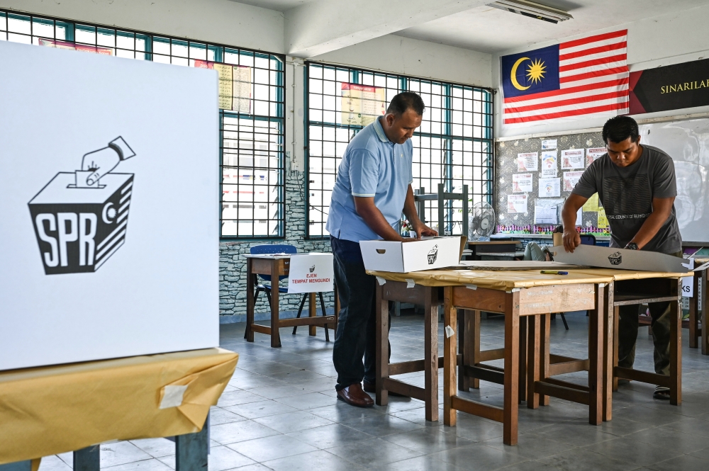Election Commission personnel setting up the polling station at Sekolah Kebangsaan Tok Jembal in Kuala Nerus August 11, 2023. ― Bernama pic
