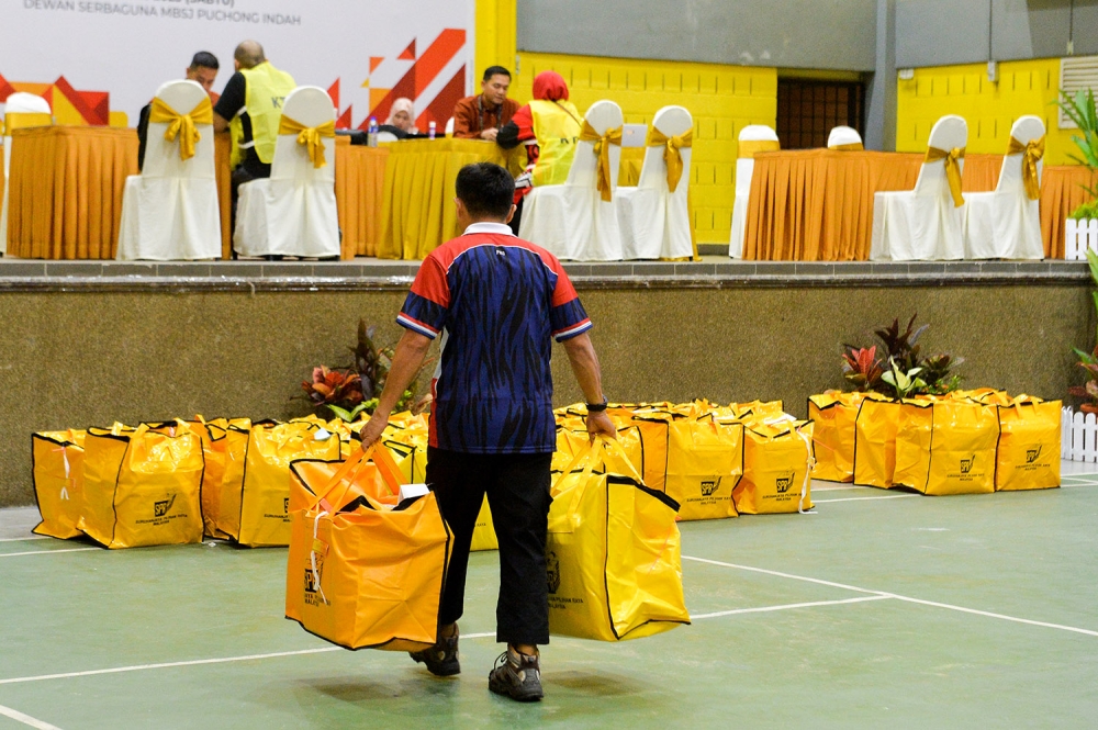 Ballot boxes arrive at the vote counting centre during state election at the Puchong Indah Multipurpose Hall August 12, 2023. — Picture by Miera Zulyana