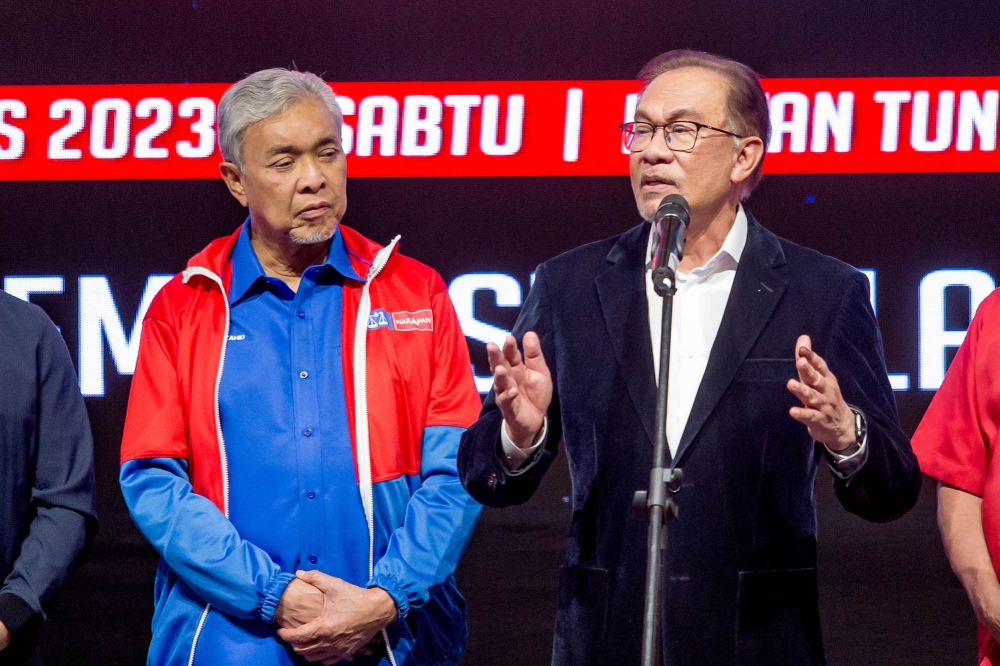 Prime Minister and Pakatan Harapan chairman Datuk Seri Anwar Ibrahim with Barisan Nasional chairman Datuk Seri Ahmad Zahid Hamidi giving a press conference during the Unity government secretariat results viewing at World Trade Centre in Kuala Lumpur August 12, 2023. — Picture by Firdaus Latif