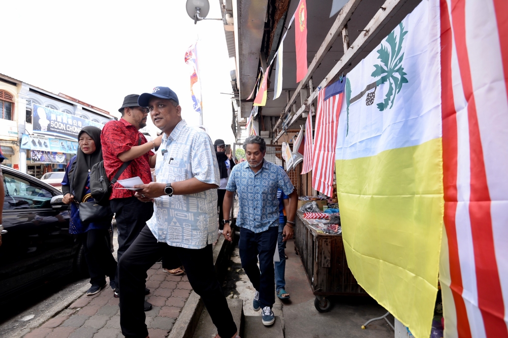 Datuk Seri Reezal Merican Naina Merican (left) and Khairy Jamaluddin campaigning in Kepala Batas town, Penang, August 10, 2023. — Picture by KE Ooi