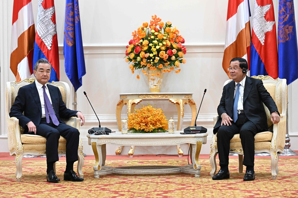 Cambodia’s Prime Minister Hun Sen (right) meeting with China’s Foreign Minister Wang Yi at the Peace Palace in Phnom Penh. — AFP pic/Cambodia’s Government Cabinet/Kok KY