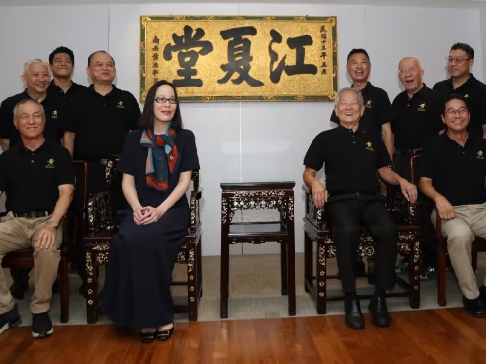 Presidential hopeful Ng Kok Song (seated, second from right) with fiancee Sybil Lau and members of the Huang Clan Association on Aug 13, 2023. — TODAY pic