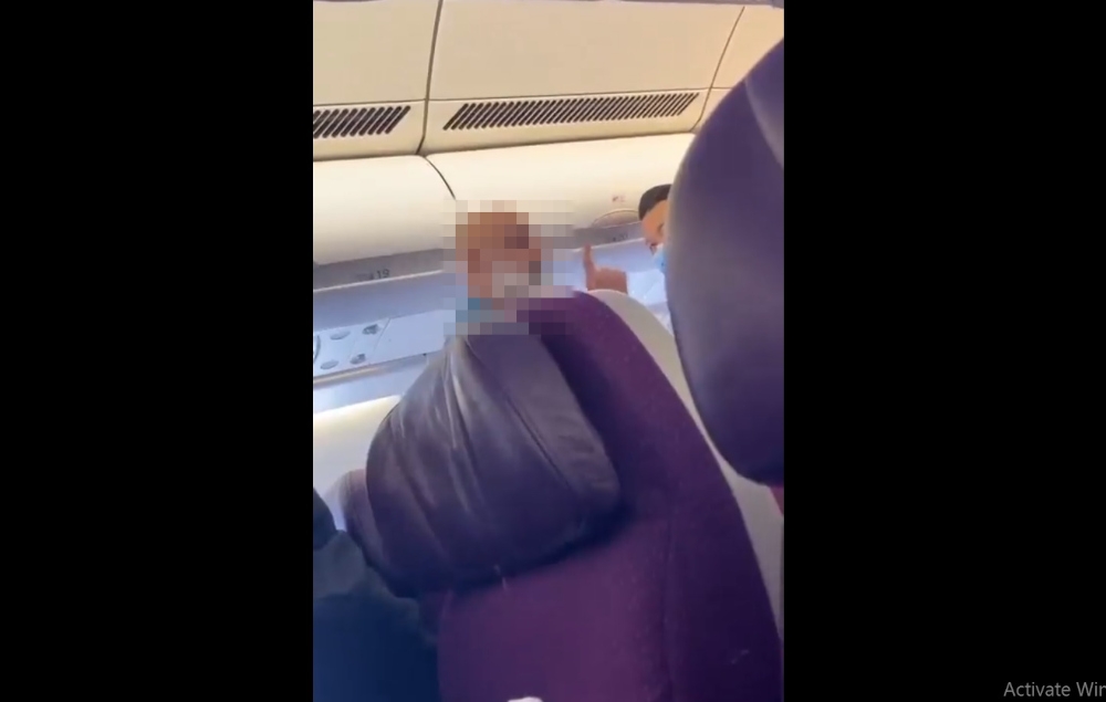 A screengrab from a video posted on social media by individuals who claimed to be onboard flight MH122 showed crew members trying to calm a man down after he began shouting at other passengers.