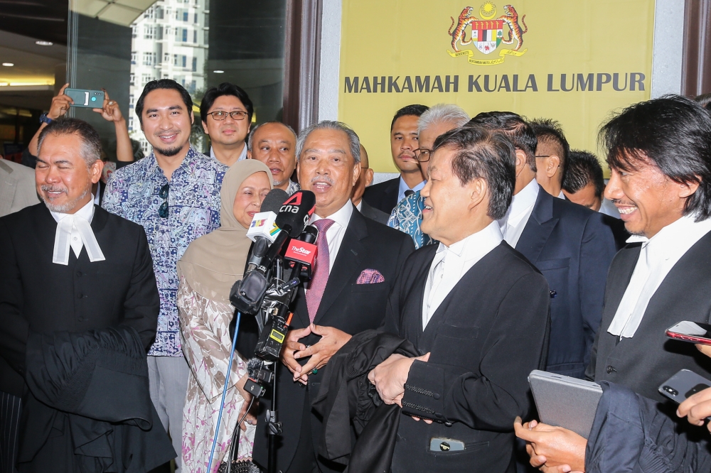 Tan Sri Muhyiddin Yassin speaks to reporters at the Kuala Lumpur High Court August 15, 2023. ― Picture by Ahmad Zamzahuri
